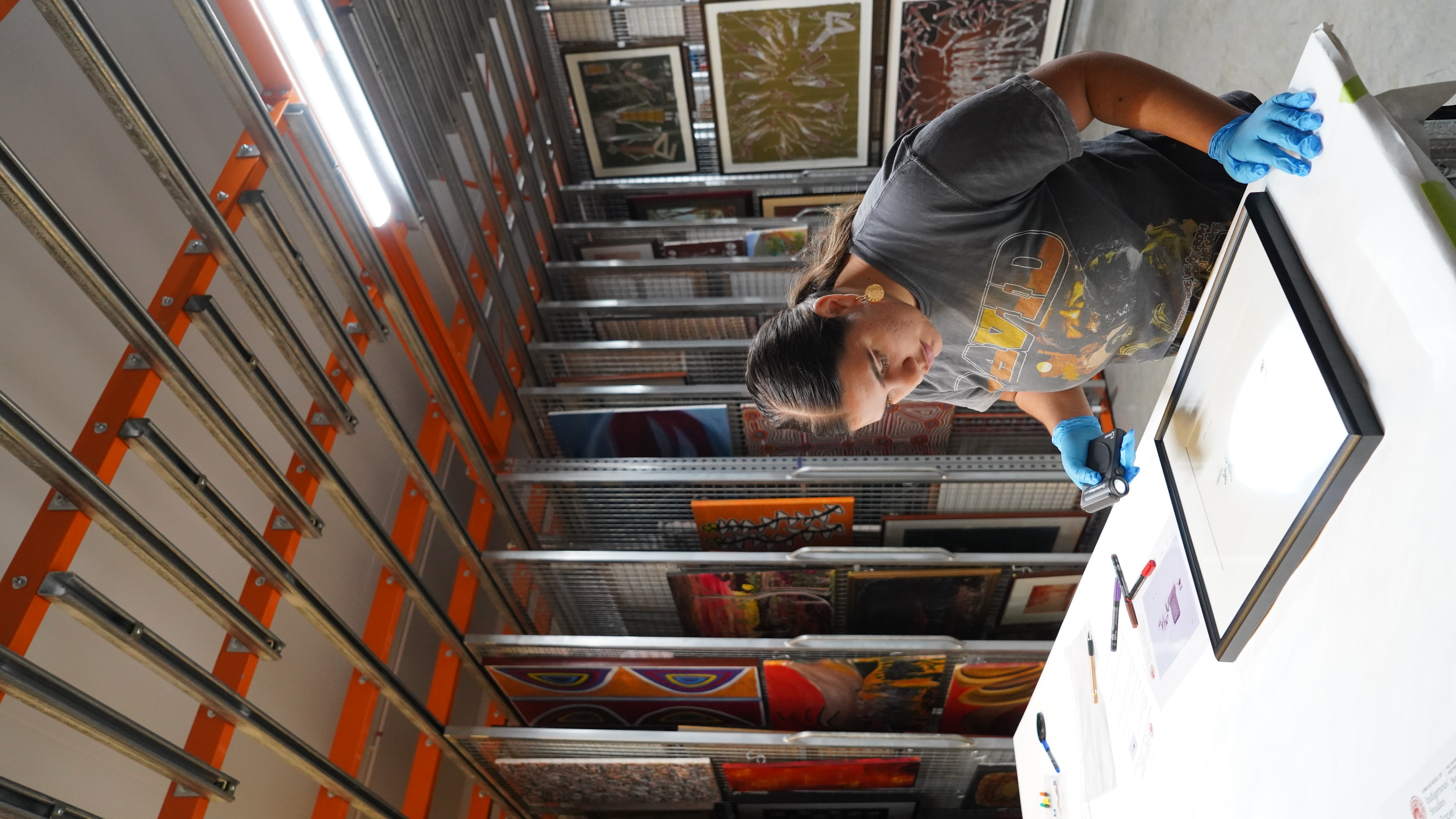 Bek Morrison examines artwork at the Berndt Museum of Anthropology