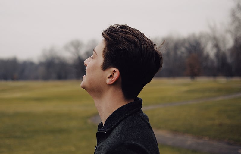 A young man standing in a field